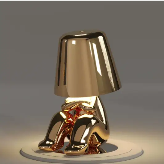 Lampe LED tactile or moderne, sans fil et rechargeable, design formes humaines, ambiance chaleureuse et décorative.