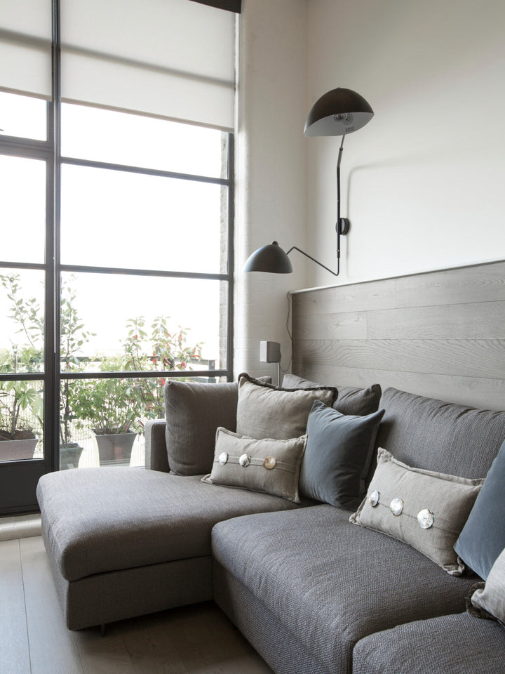 "Lampe murale moderne avec bras orientable, design organique années 50, finition métal noir, idéale pour intérieur épuré."