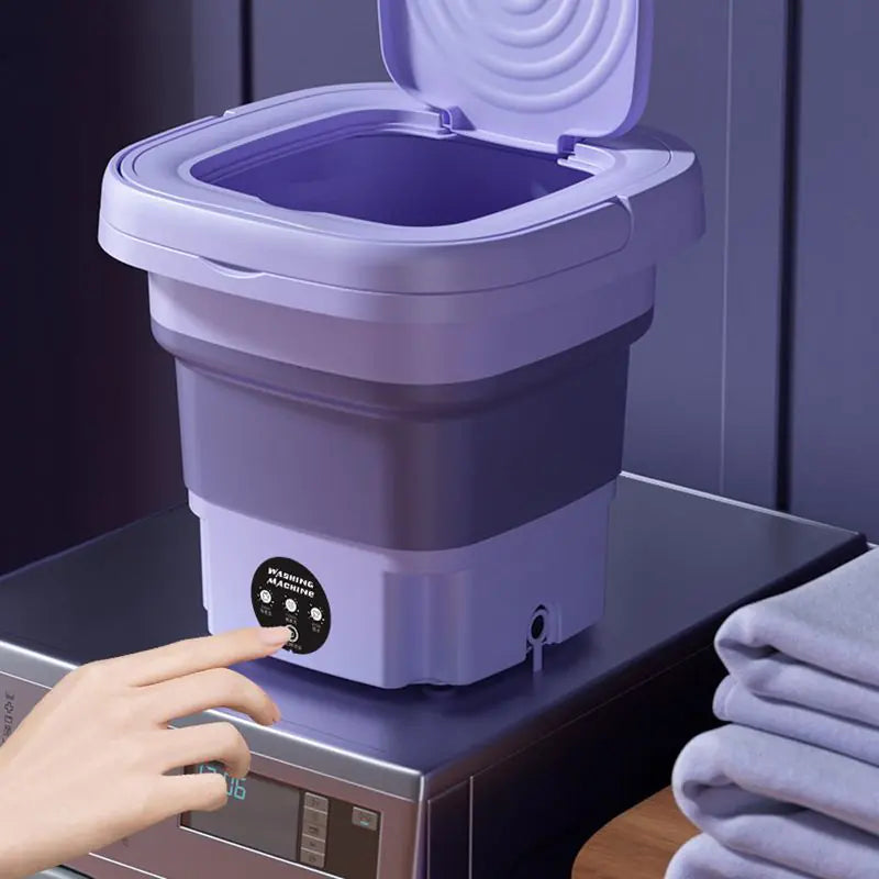 Machine à laver portable pliable. Lavage efficace et compact, idéal pour petits espaces. Gain de place garanti.