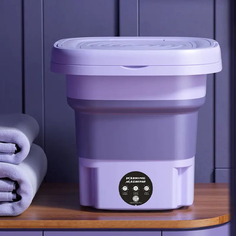Machine à laver portable pliable. Lavage efficace et compact, idéal pour petits espaces. Gain de place garanti.
