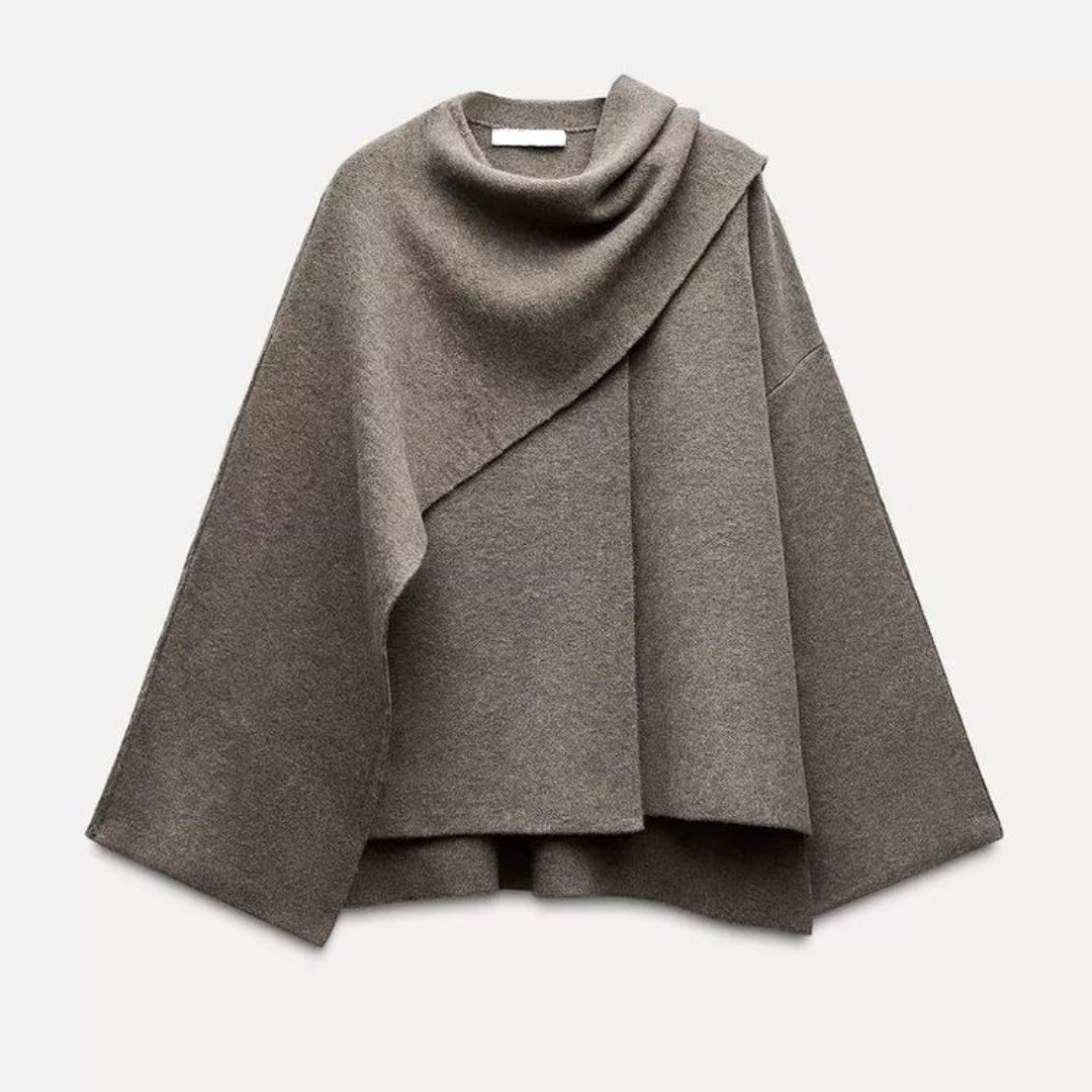 "Manteau cape femme chic automne, design asymétrique gris, tissu doux, style moderne et confortable pour temps frais."