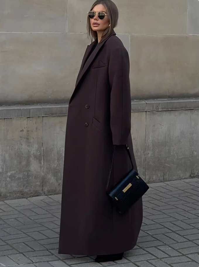 "Manteau long classique femme hiver élégant avec col imposant, coupe ajustée, couleur neutre, idéal saisons froides."