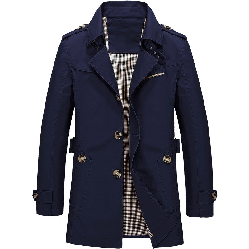 "Manteau trench homme élégant avec coupe structurée, doublure lisse, épaulettes marquées et style croisé sophistiqué."