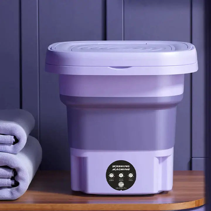 "Mini machine à laver portable violette, compacte et pliable, design moderne, lavage efficace et transport facile."