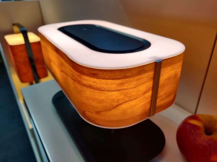 Modern tree-shaped desk lamp with wireless charging & Bluetooth speaker. Adjustable light, elegant design.