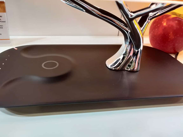 Modern tree-shaped desk lamp with wireless charging & Bluetooth speaker. Adjustable light, elegant design.