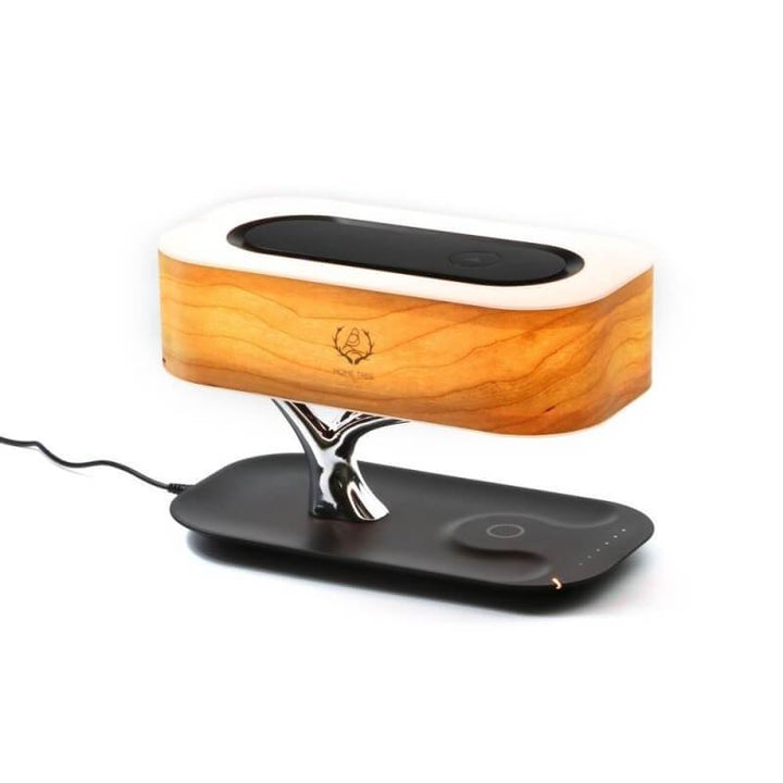 Modern tree-shaped desk lamp with wireless charging & Bluetooth speaker. Adjustable light, elegant design.