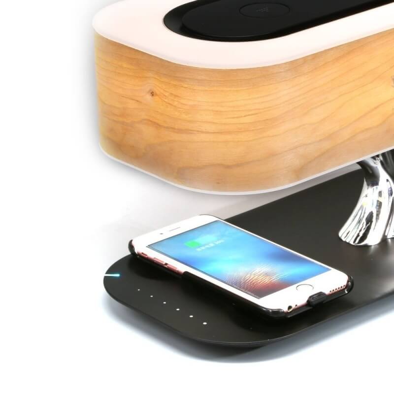 Modern tree-shaped desk lamp with wireless charging & Bluetooth speaker. Adjustable light, elegant design.