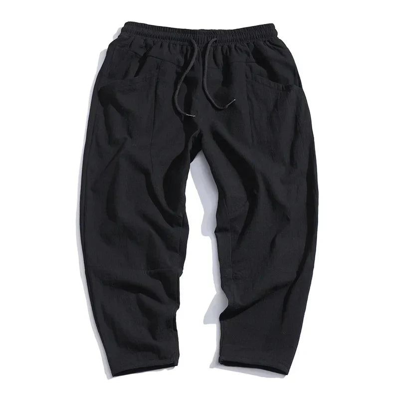 "Pantalon croppé homme en lin léger, couleurs blanc, indigo, khaki, noir. Élégant et confortable pour un style moderne."