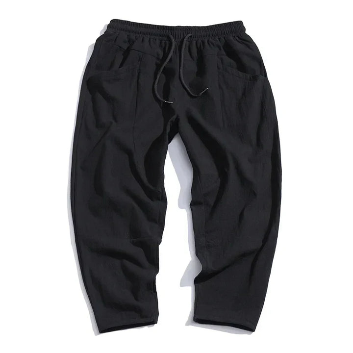"Pantalon croppé homme en lin léger, couleurs blanc, indigo, khaki, noir. Élégant et confortable pour un style moderne."