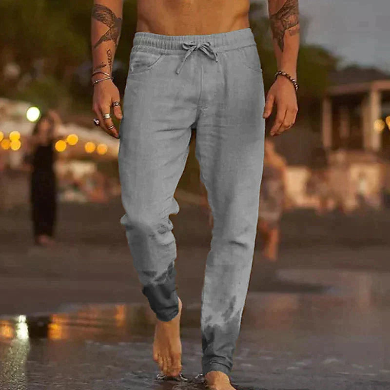 "Pantalon en lin homme, coupe ample, léger, gris clair, taille élastique, style chic et décontracté parfait pour l'été."