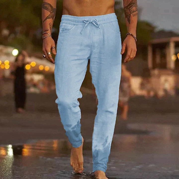"Pantalon en lin homme, coupe ample, léger, gris clair, taille élastique, style chic et décontracté parfait pour l'été."