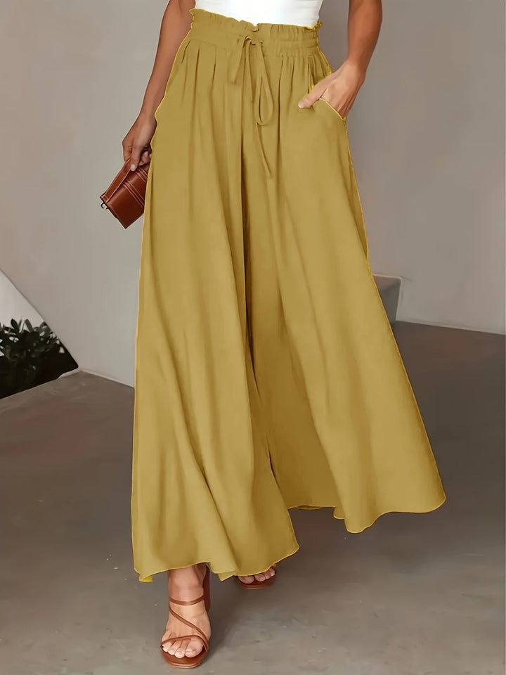 Pantalon femme ample noir à taille élastique, parfait pour la mode décontractée ou chic, toutes saisons.