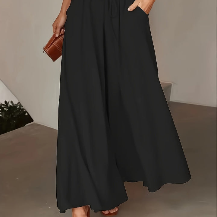 Pantalon femme noir taille élastique, coupe jambe large, pour un confort optimal et un style élégant sans effort.
