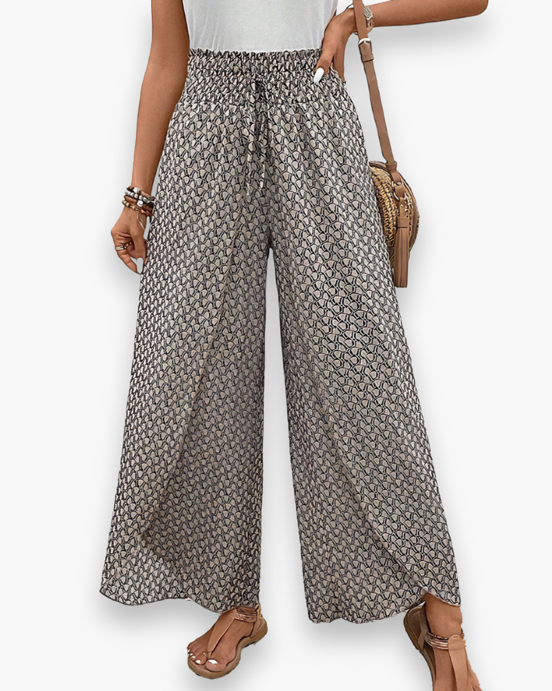 Pantalon large femme, imprimé graphique moderne, coupe fluide, taille élastique, confort chic et décontracté.