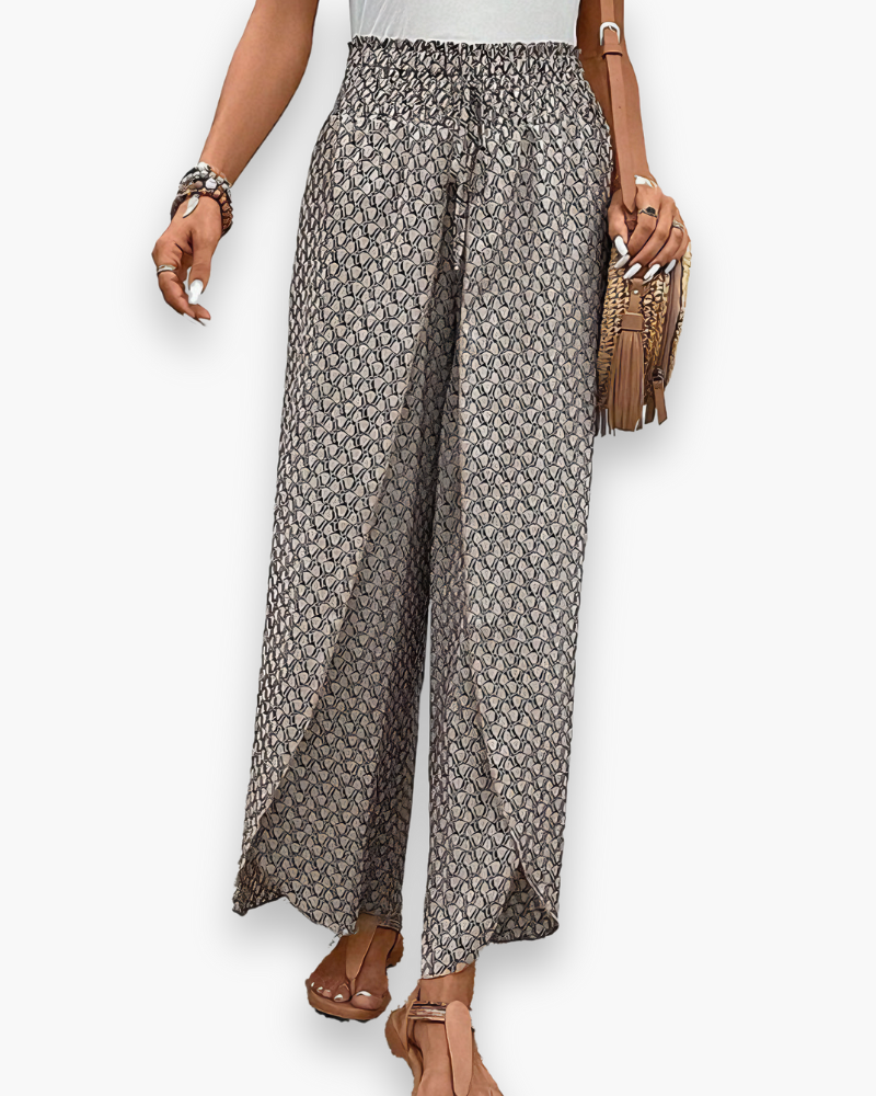 Pantalon large femme, imprimé graphique moderne, coupe fluide, taille élastique, confort chic et décontracté.