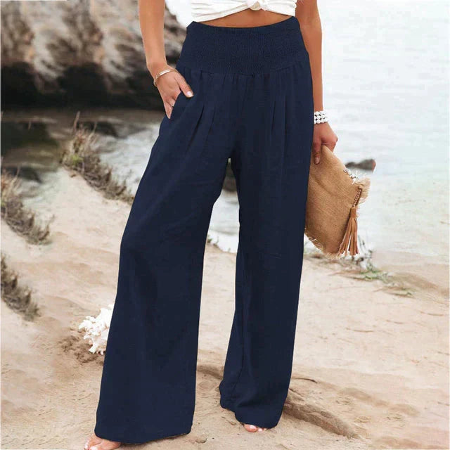 Femme portant un pantalon large élégant et confortable, couleur neutre, pour une tenue chic et un style féminin décontracté.