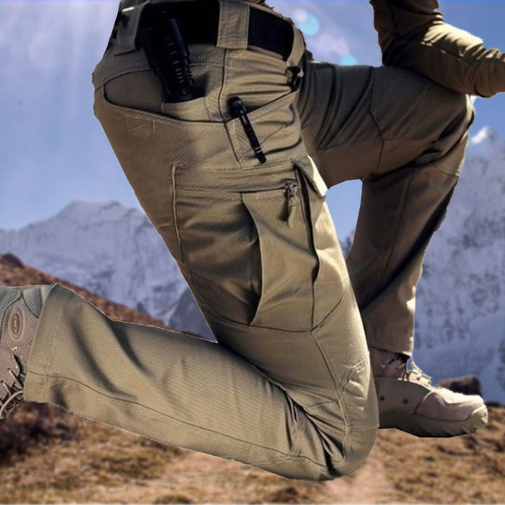 Pantalon tactique stretch homme, coupe cargo robuste, imperméable, idéal extérieur, randonnée, travail.