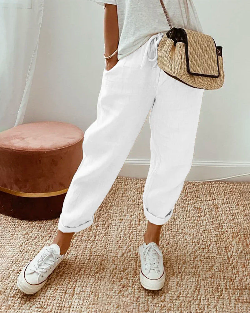 "Pantalon uni en coton lin beige pour femme, léger et élégant, idéal pour l'été, coupe ajustée et confortable."