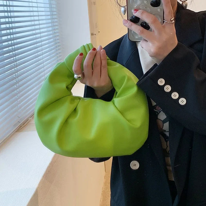 Élégant petit sac à main pour femme, style soirée, rond en cuir synthétique, idéal pour un look chic et compact.