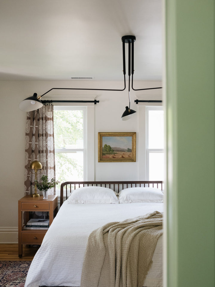 Plafonnier moderne à bras ajustable en métal noir, design élégant et épuré, pour éclairage directionnel contemporain.