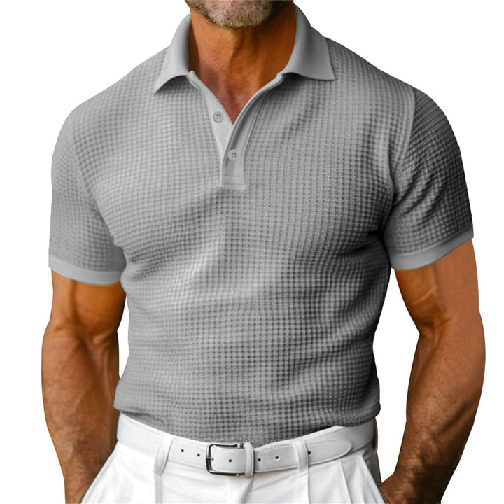 Polo homme gaufré classique bleu marine, élégant et décontracté, parfait pour l'été. Confort respirant.