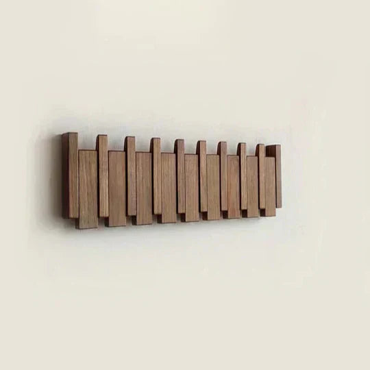 "Porte-manteau mural design piano bois noyer et hêtre, élégant et moderne, idéal pour suspensions variées."