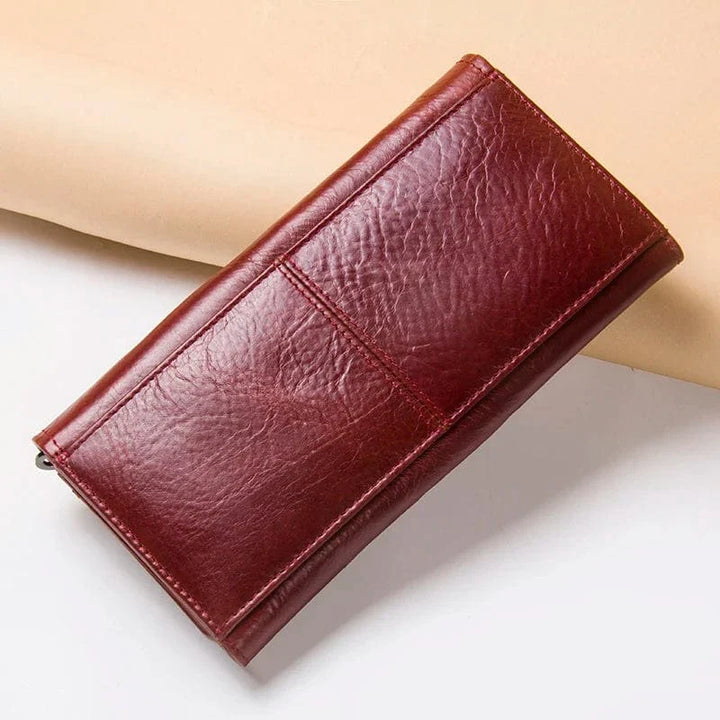 Portefeuille femme en cuir véritable marron avec fermeture éclair dorée, élégant et pratique.