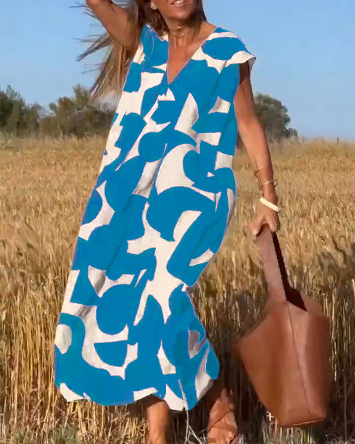 "Robe Camille élégante à imprimé moderne avec col en V flatteur, parfaite pour toutes occasions et toutes saisons."