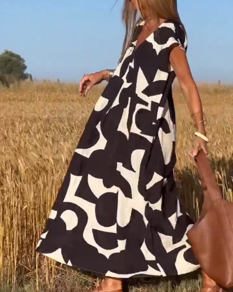 "Robe Camille élégante à imprimé moderne avec col en V flatteur, parfaite pour toutes occasions et toutes saisons."