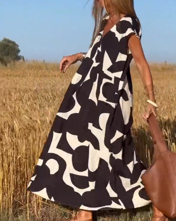 "Robe Camille élégante à imprimé moderne avec col en V flatteur, parfaite pour toutes occasions et toutes saisons."