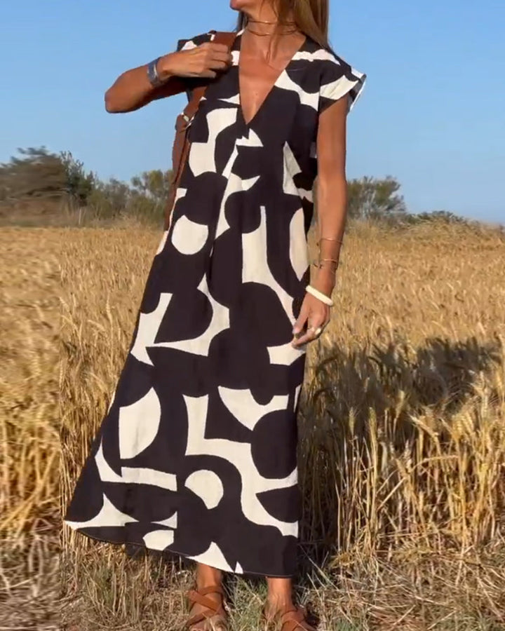 "Robe Camille élégante à imprimé moderne avec col en V flatteur, parfaite pour toutes occasions et toutes saisons."