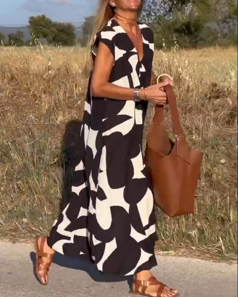 "Robe Camille élégante à imprimé moderne avec col en V flatteur, parfaite pour toutes occasions et toutes saisons."