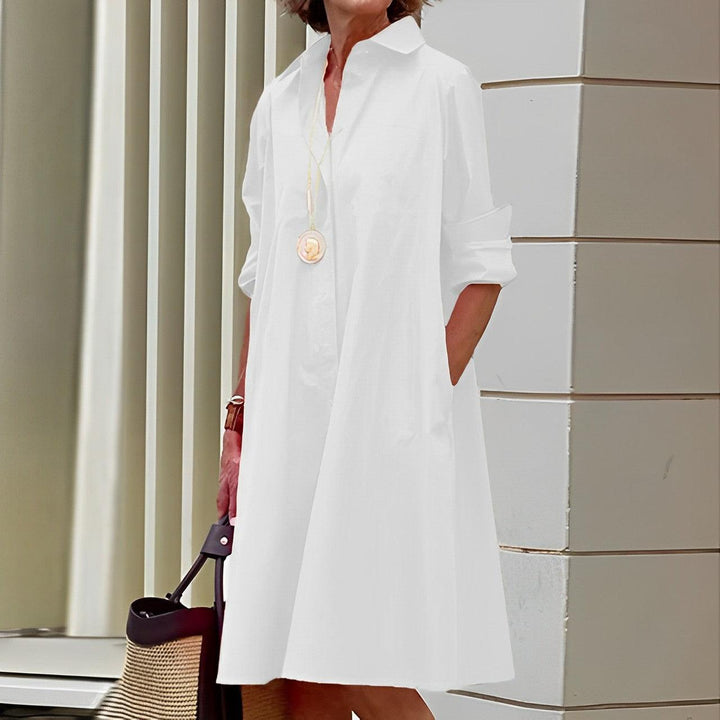 Robe chemise femme coupe fluide, col rabattu, manches 3/4, style chic et tendance pour l'été.