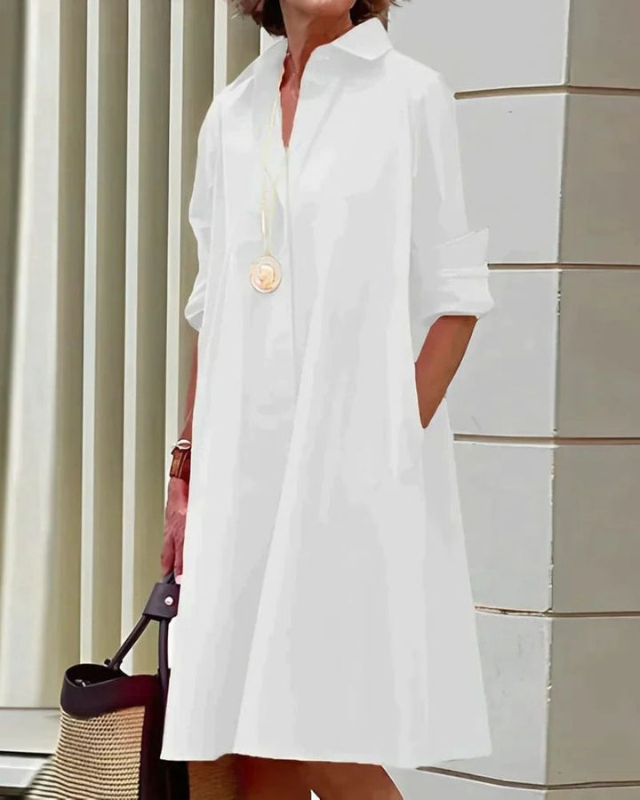 Élégante robe chemise femme Monet midi, col classique, manches longues boutonnées, poches discrètes. Confort et style.