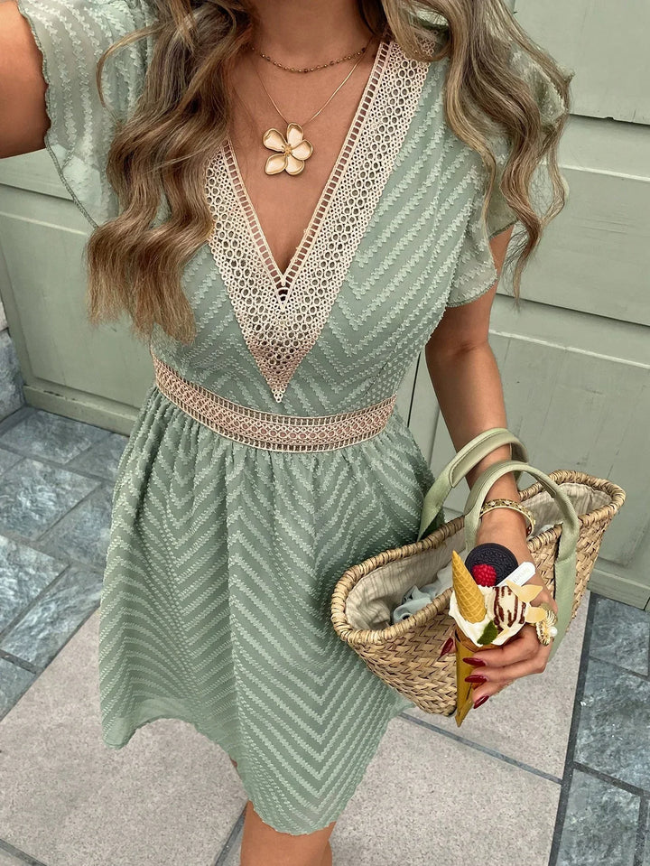 Robe d'été légère courte verte, style bohème chic. Idéale pour les vacances, avec des détails en crochet délicats.