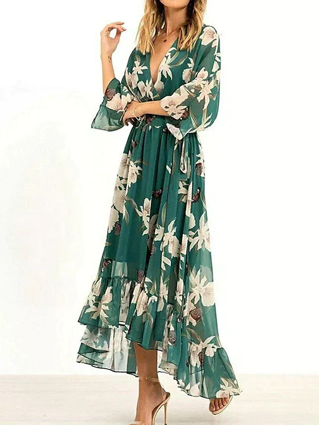 Robe de femme ceinturée vert émeraude, style cocktail avec volants, élégante et féminine pour toute occasion spéciale.