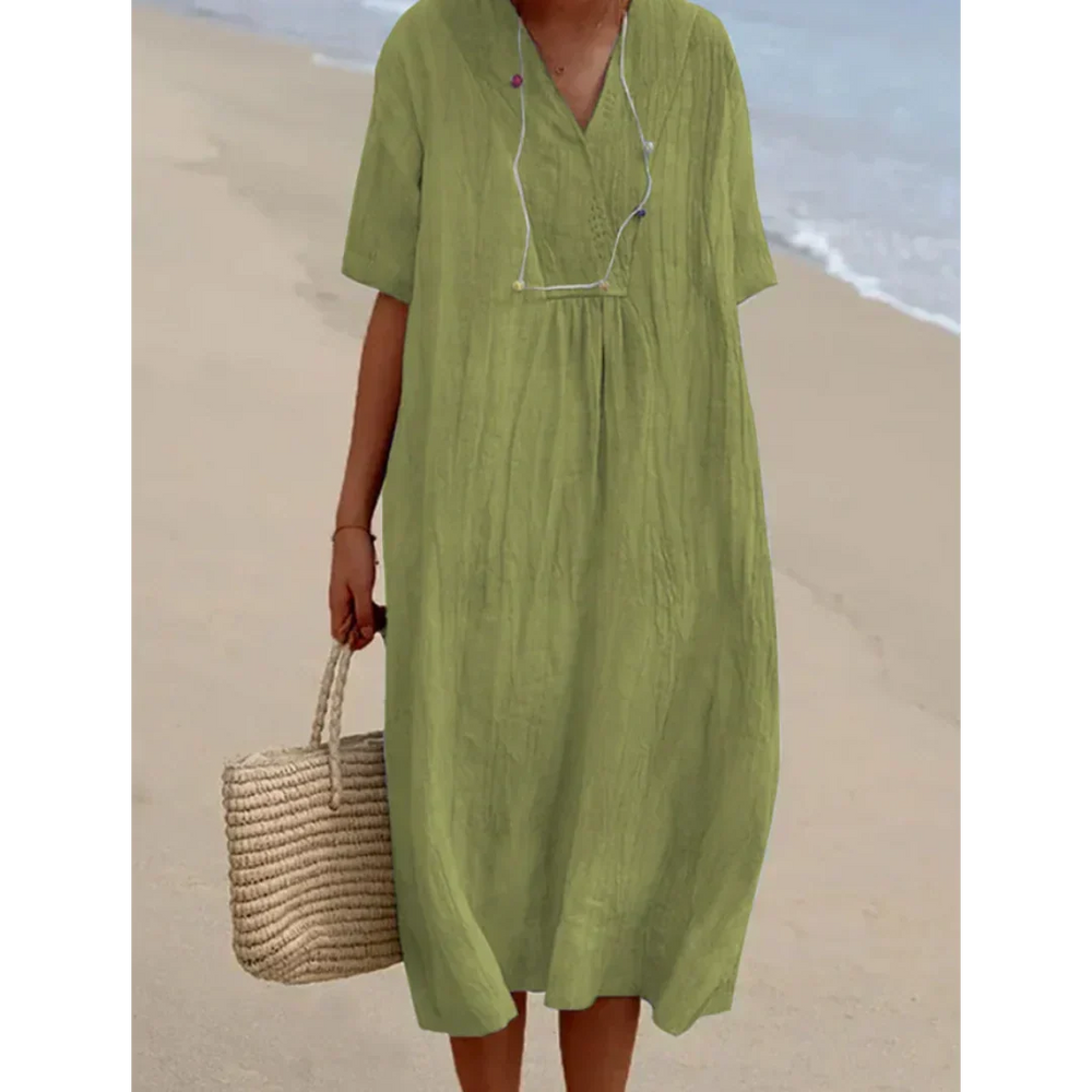 Robe fluide midi femme, idéale pour la plage et les journées d'été décontractées. Style moderne et confortable.