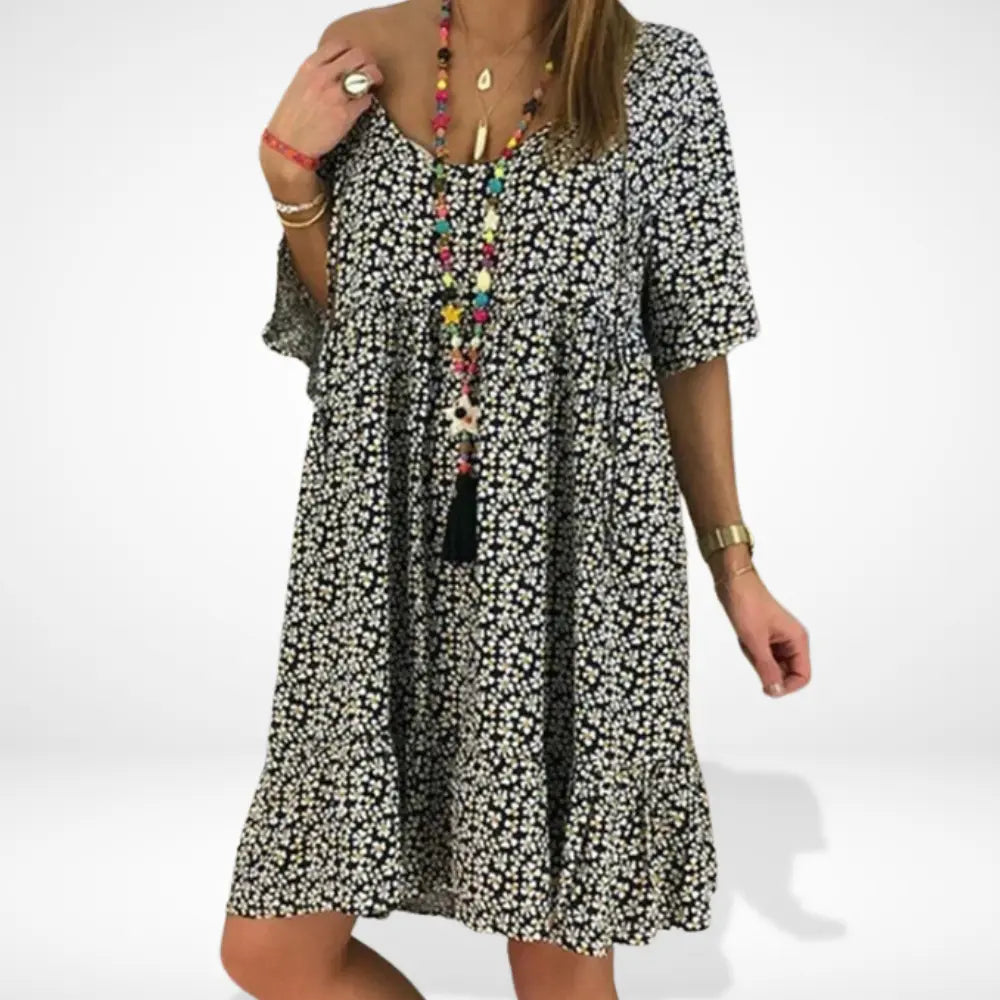 "Robe d'été fluide à motif fleuri contrasté, manches 3/4, couleurs vibrantes pour femme, coupe aérienne, mode estivale."