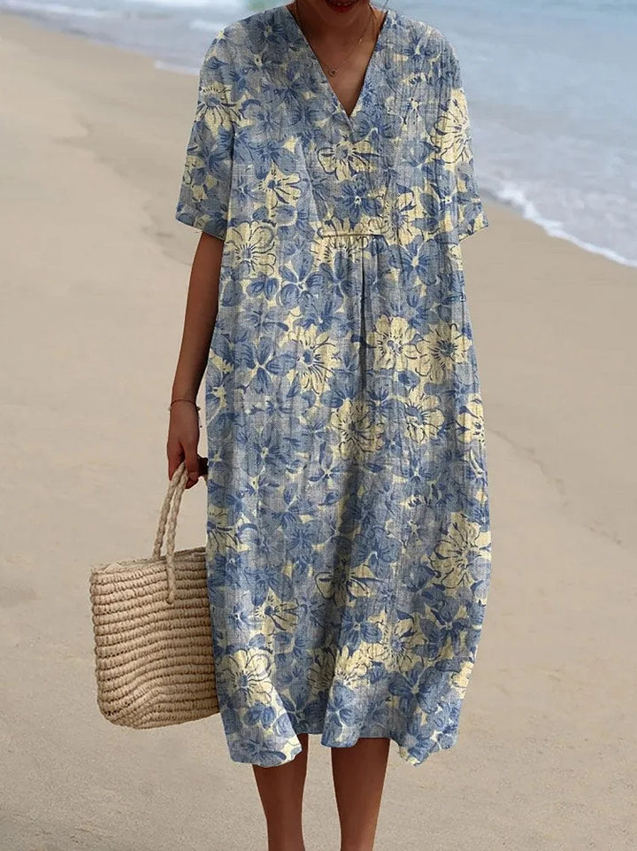 "Robe fluide féminine avec imprimé floral rétro, coupe ample et matériaux légers, idéale pour une allure vintage chic."