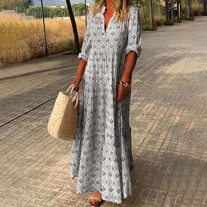 "Robe longue bohème bleu clair à motif feuillage, manches 3/4 retroussables pour un look léger et élégant"