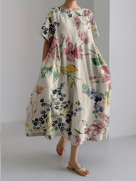 "Robe longue en lin beige clair avec motif floral coloré, coupe ample, manches courtes pour confort estival"