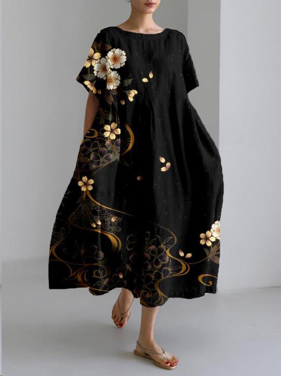 "Robe longue en lin beige clair avec motif floral coloré, coupe ample, manches courtes pour confort estival"