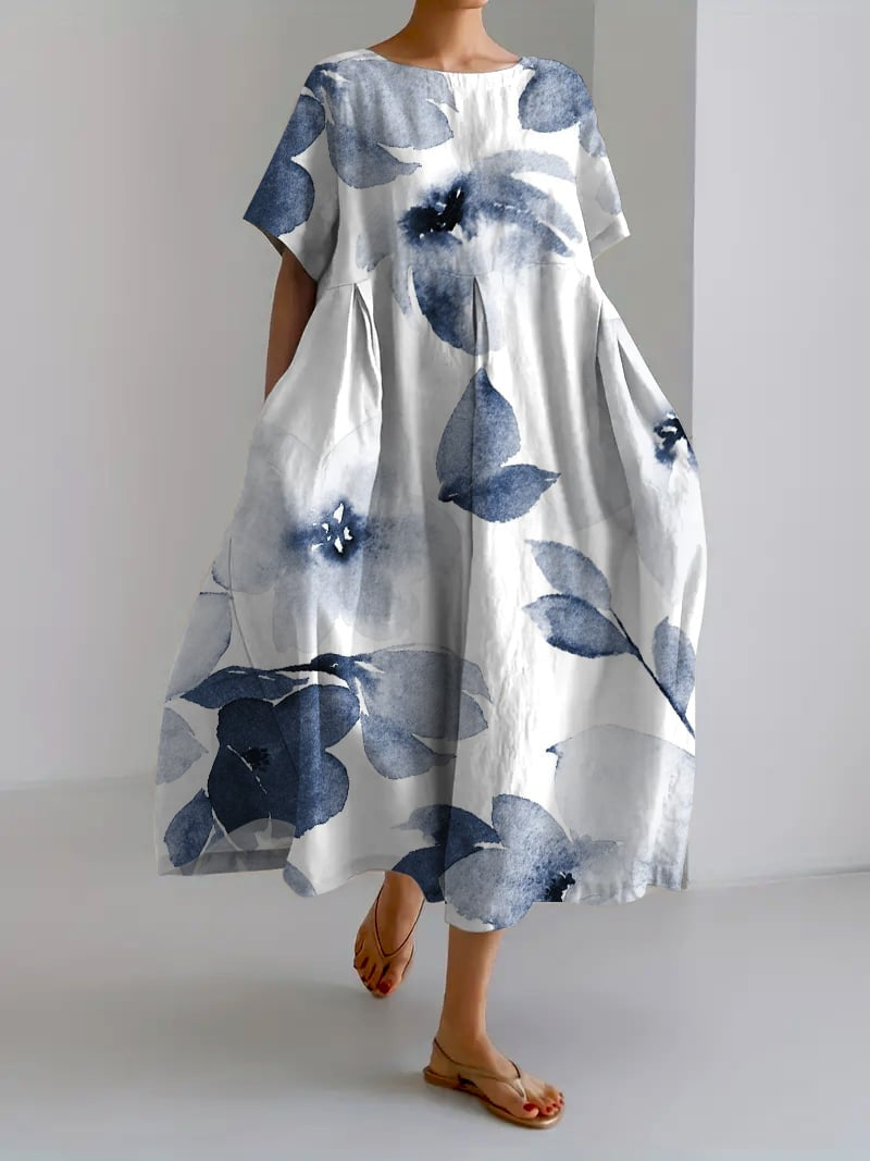 "Robe longue en lin beige clair avec motif floral coloré, coupe ample, manches courtes pour confort estival"