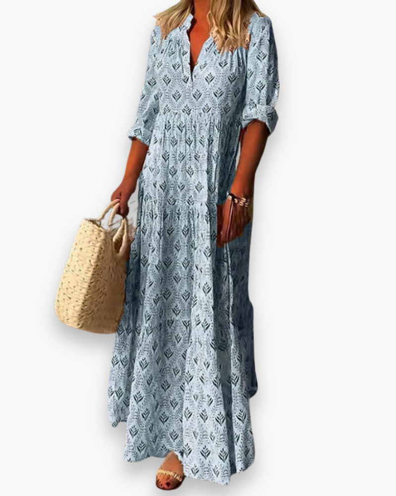 "Robe longue fleurie style bohème chic, coupe fluide et col V, idéale pour l'été et les sorties ensoleillées."