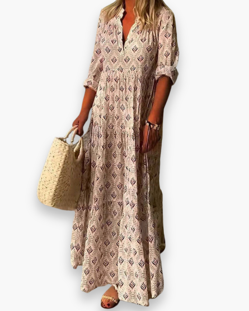 "Robe longue fleurie style bohème chic, coupe fluide et col V, idéale pour l'été et les sorties ensoleillées."