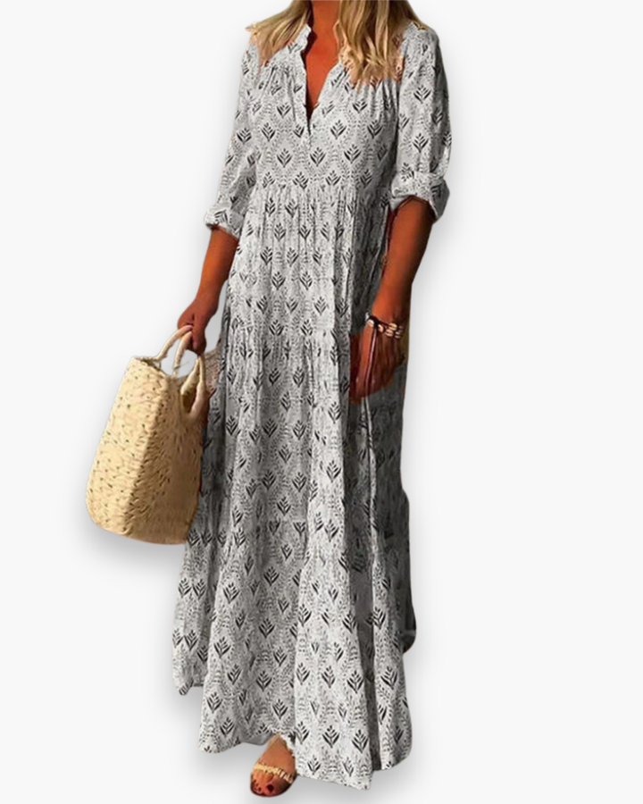 "Robe longue fleurie style bohème chic, coupe fluide et col V, idéale pour l'été et les sorties ensoleillées."