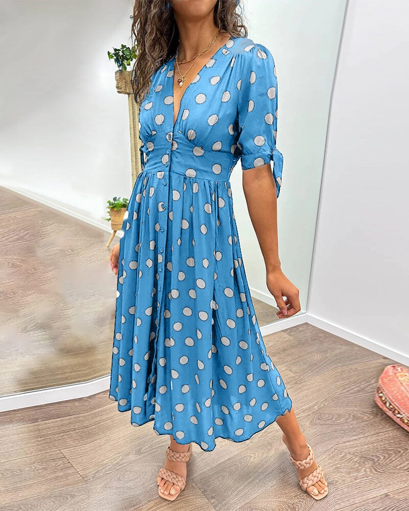 "Robe mi-longue à pois, manches nouées, coupe cintrée, imprimé rétro, parfaite pour occasions élégantes."