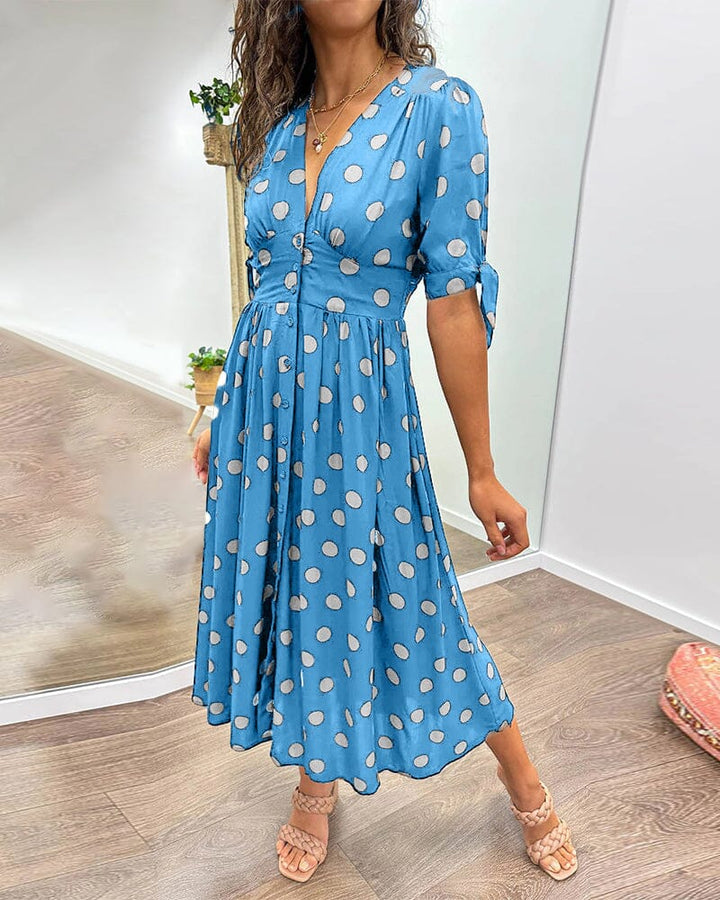 "Robe mi-longue à pois, manches nouées, coupe cintrée, imprimé rétro, parfaite pour occasions élégantes."