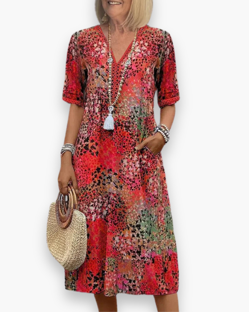 "Robe midi élégante pour femme avec imprimé raffiné, coupe flatteuse et poches pratiques, idéale pour toute occasion."